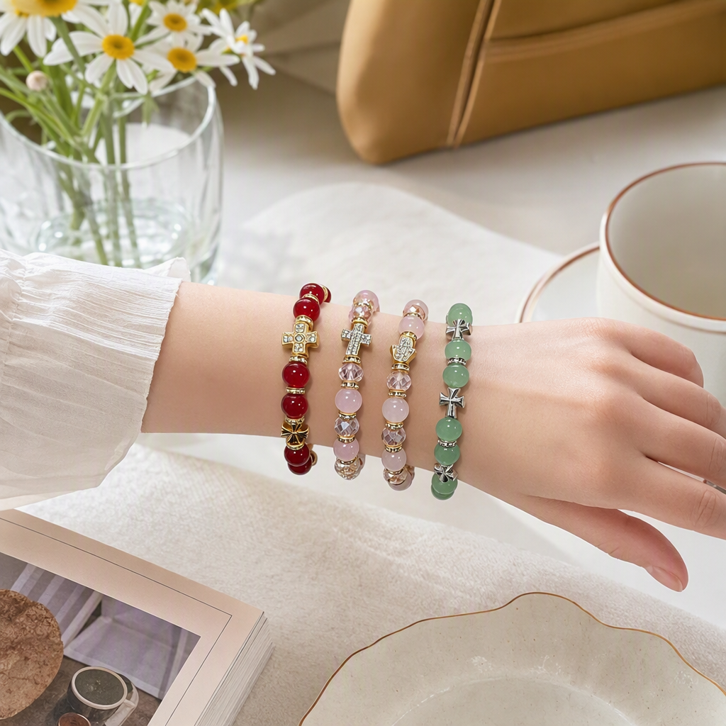 The white hand model showcases a multi-color bead bracelet in red, pink and green tones, paired with a metal cross-shaped hand accessory, making it a fashionable hand accessory details Picture