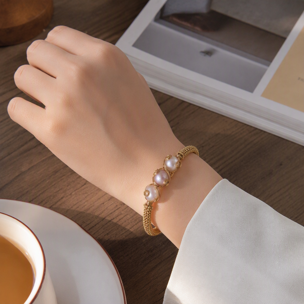 A simple and elegant ladies' bracelet gift featuring a golden woven bracelet paired with pearl fashion jewelry details Picture
