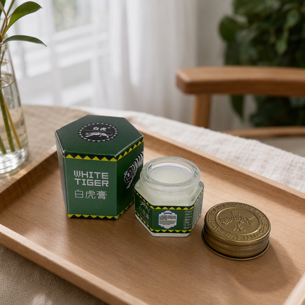 The White Tiger Ointment is packaged in a green hexagonal box with a golden lid. It is a fresh and elegant medicine box for collection details Picture