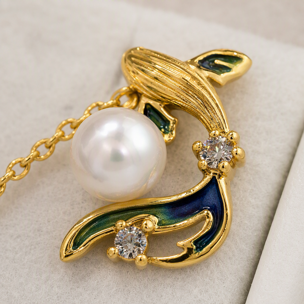 The golden fish-shaped pearl earrings set includes two stud earrings and a pendant. It is decorated with blue and green enamel pearl zircon and stored in a white velvet box Application Scenario
