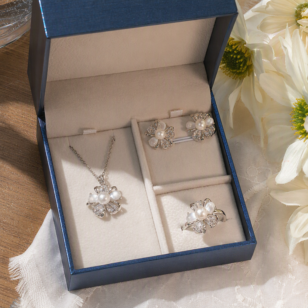 A blue jewelry box with white padding, silver flowers, pearls, diamonds, necklaces, stud rings, and a fashionable and elegant accessory gift box details Picture