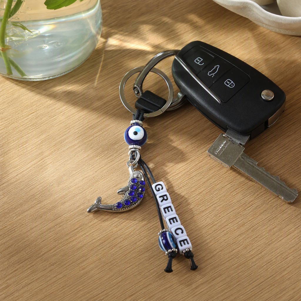 Silver keychain with blue Devil's eye dolphin pendant, white letter beads, blue and white stripes, Devil's Eye packaging card plate accessory details Picture
