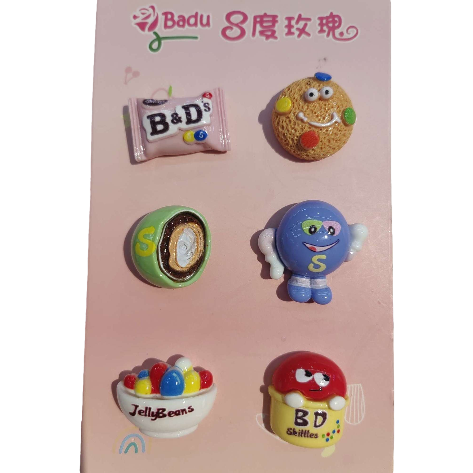 Six colorful candy-themed tiles with a pink background, B&D's chocolate cookie face, S-shaped egg roll, Smurfs, Jelly Beans, BD Skittles rainbow Item Picture