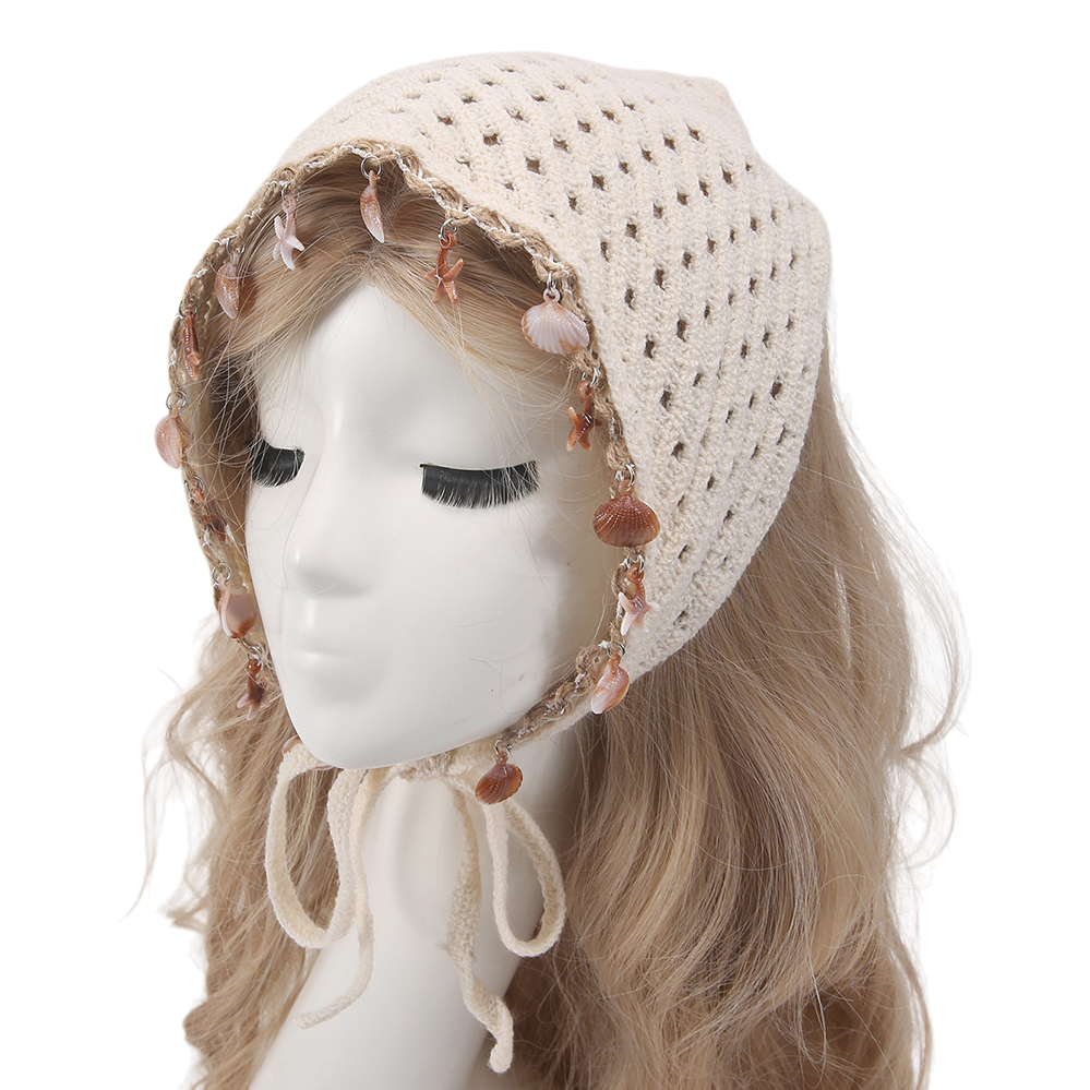 A creative handmade accessory display prop featuring a beige crocheted headscarf decorated with a shell and starfish pendant and a dummy head model Item Picture
