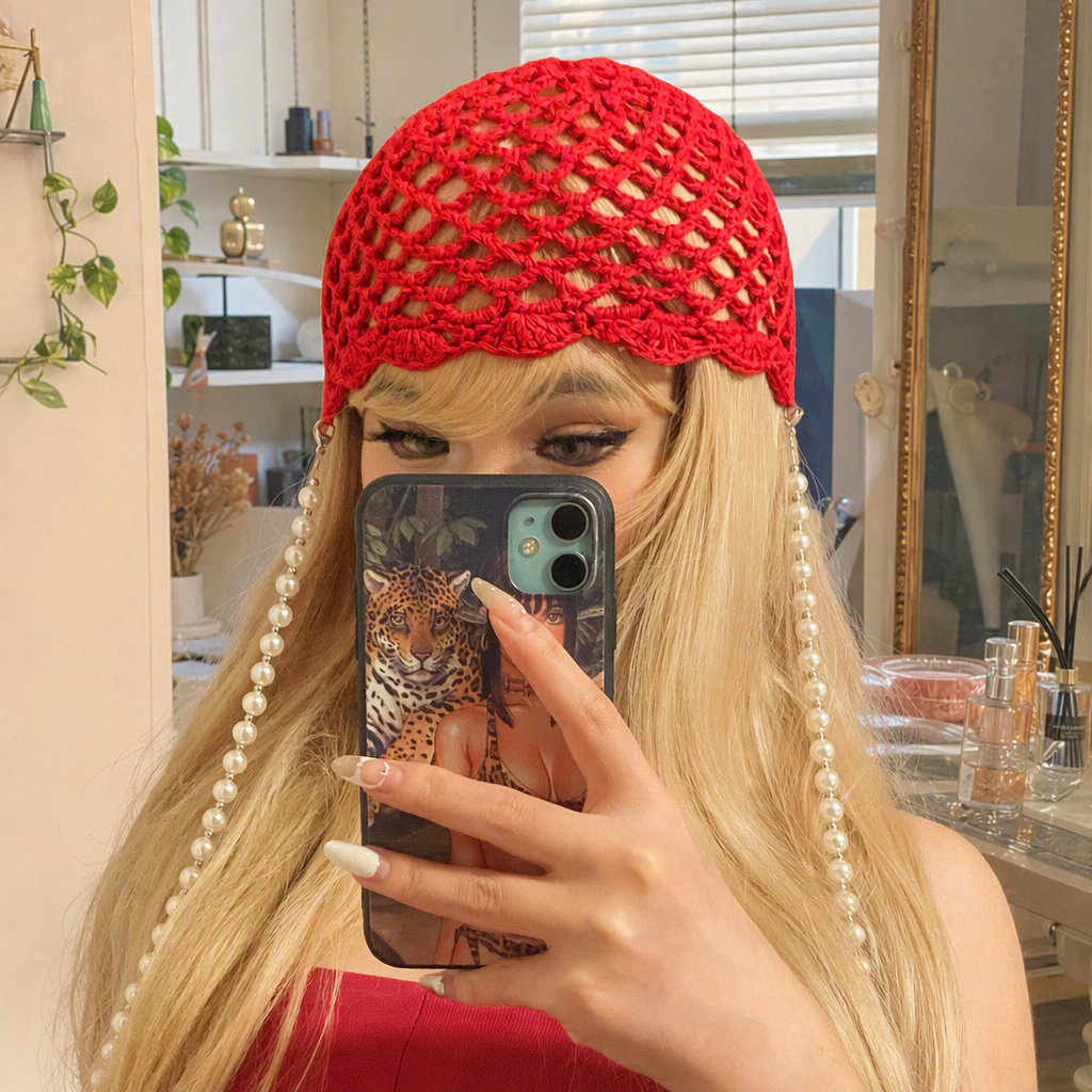 Blonde women with a red crochet hat and pearl tassels, a fashionable and versatile trendy hat accessory for women's autumn and winter details Picture