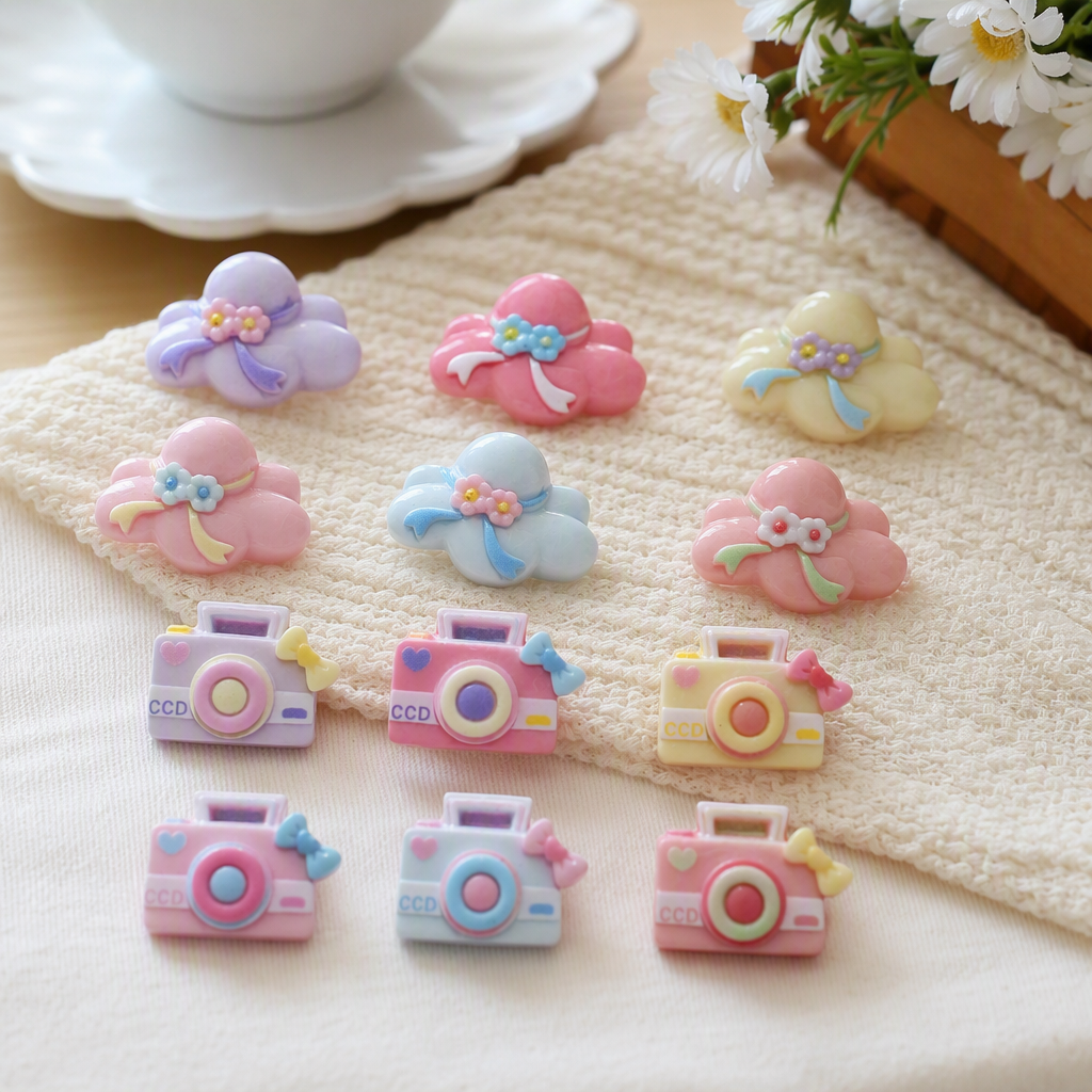 Pink background cloud camera-shaped accessories in purple, pink and yellow with small flower bows in a retro style details Picture