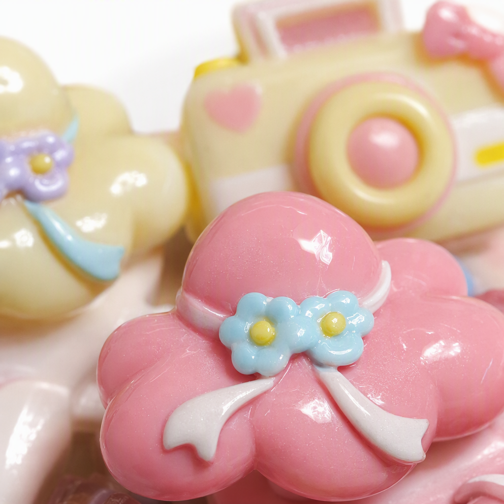 Pink background cloud camera-shaped accessories in purple, pink and yellow with small flower bows in a retro style Application Scenario