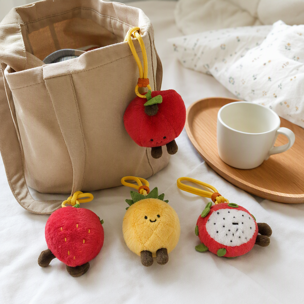 Four cute fruit-shaped plush pendants: red strawberry pitaya and yellow pineapple. Fun handcrafted fabric pendants for gift bags details Picture