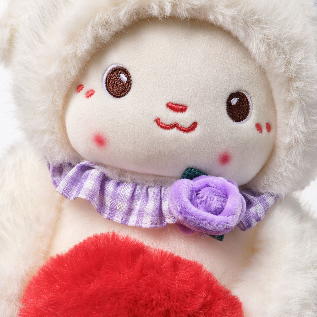 A cute white plush sheep doll with a purple lace hat and striped scarf, holding a red pom-pom bouquet as a children's fabric gift Application Scenario