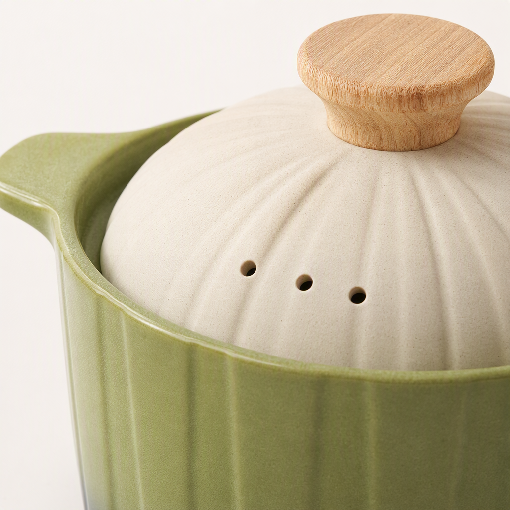 The multi-functional ceramic stew pot is green and brown with a wooden handle and white with a hole cover. It is a household soup pot that is heat-resistant and durable Application Scenario