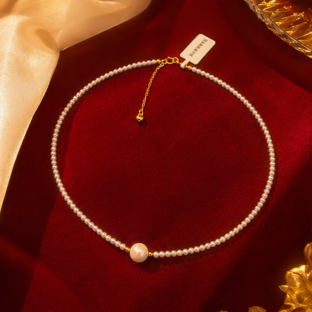 The white pearl necklace is delicately strung with a large, round pearl in the center. It features a golden clasp and a heart-shaped pendant, making it an elegant accessory Specification image