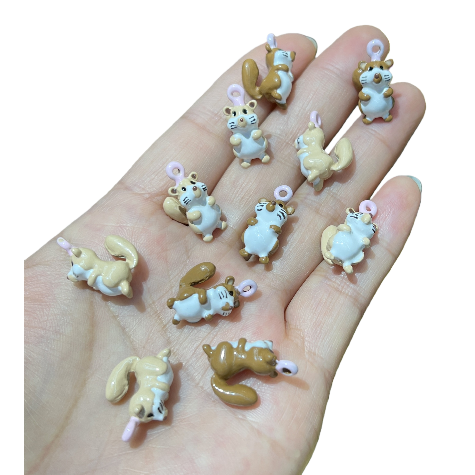 A creative gift featuring multiple brown and white squirrel resin pendants held in the palm, cute animal ornaments Item Picture