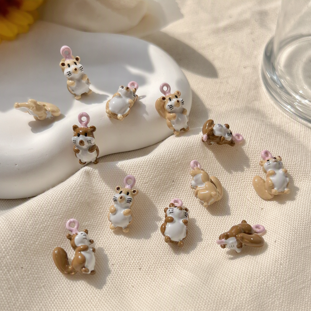 A creative gift featuring multiple brown and white squirrel resin pendants held in the palm, cute animal ornaments details Picture