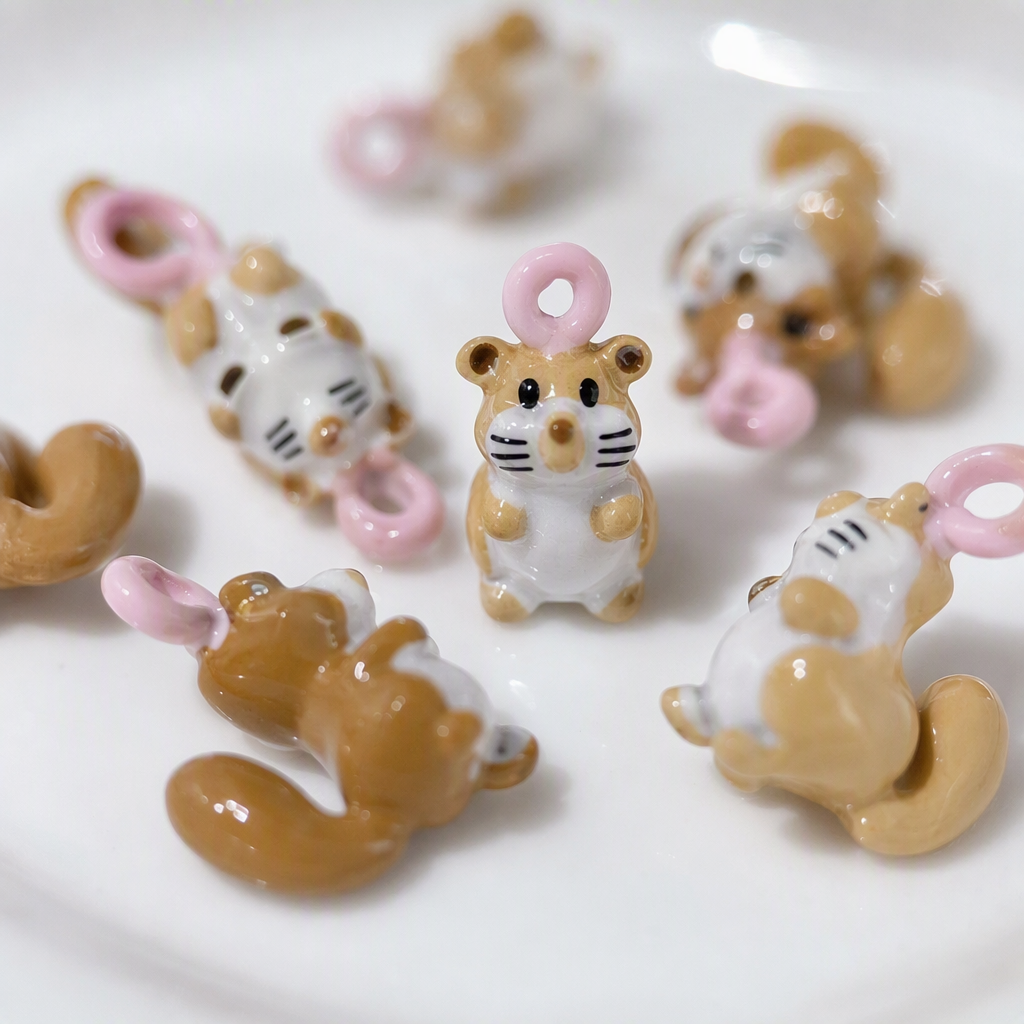A creative gift featuring multiple brown and white squirrel resin pendants held in the palm, cute animal ornaments Application Scenario