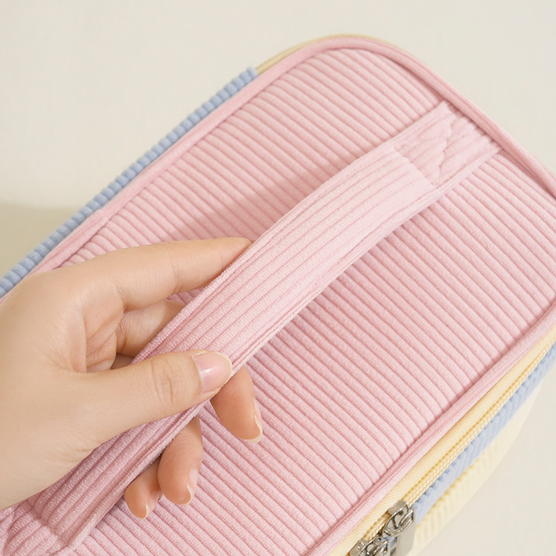 Corduroy double-layer hand-held makeup bag, portable large-capacity makeup storage bag, built-in makeup brush, independent compartment, travel skin care products, separate storage, toiletries bag, macaron girls' beauty bag Application Scenario