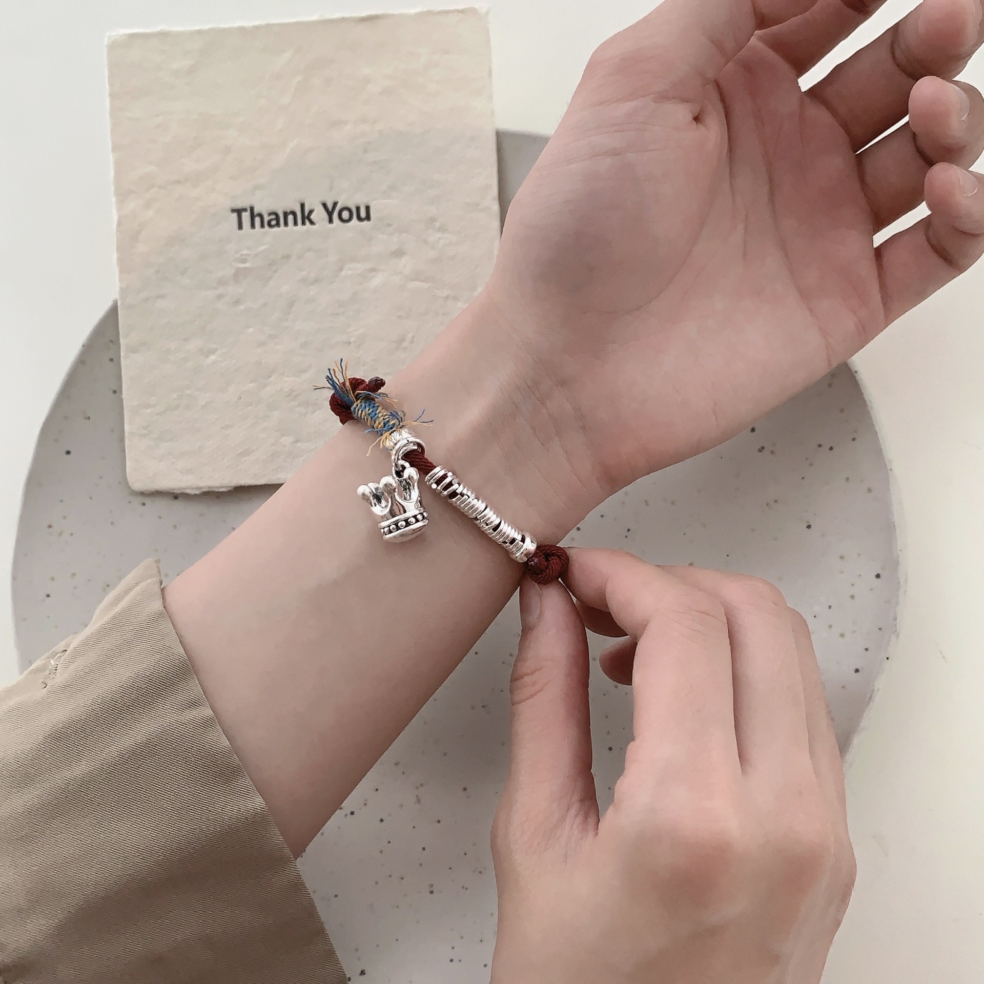 A unique and retro 12.12 crown coiled red string S925 sterling silver bracelet with a niche design, exuding a sense of light luxury and high-end fashion pic 2