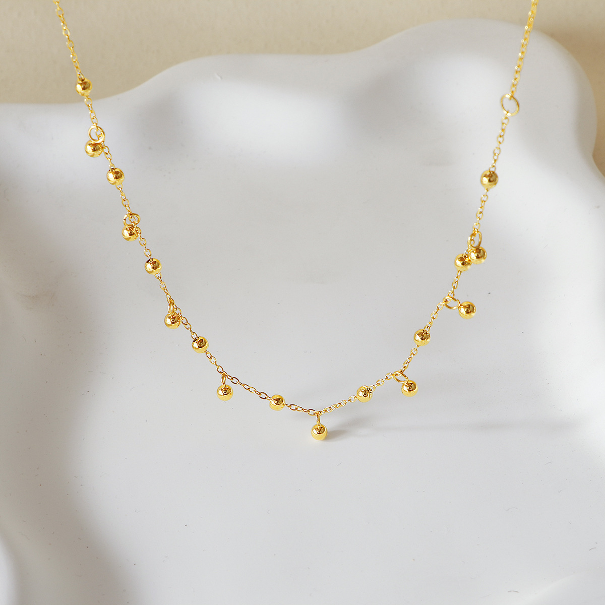 A popular 18K gold bean-shaped tassel necklace in Europe and America, featuring a minimalist and high-end look, is a versatile titanium steel collarbone necklace that goes well with a cold style on Instagram pic 1