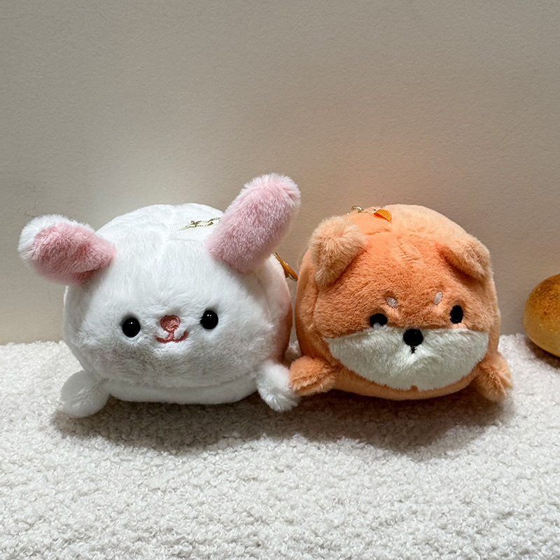 The little cat doll that wags its tail by pulling a rope is called the popular little white rabbit plush toy backpack doll at the street stall pic 9