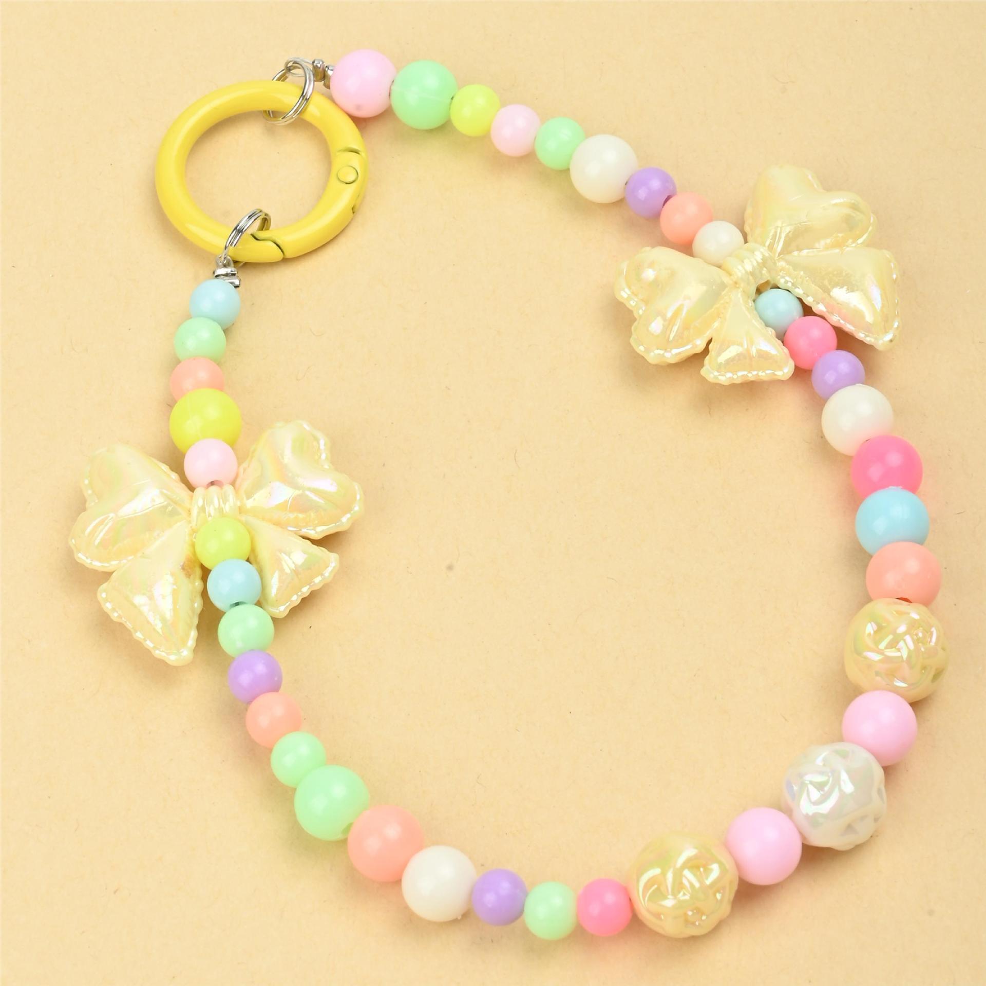 Wholesale of new colored candy-colored mobile phone chains, bows, beads, bag chains, water cup chains, car keychains and pendants pic 1