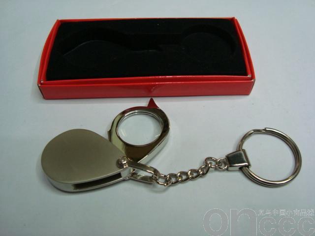 Folding magnifying glass of metal