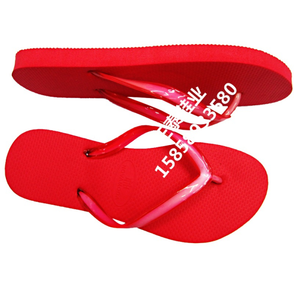 Bright red, unprinted women's casual and elegant flip-flops on the beach details Picture