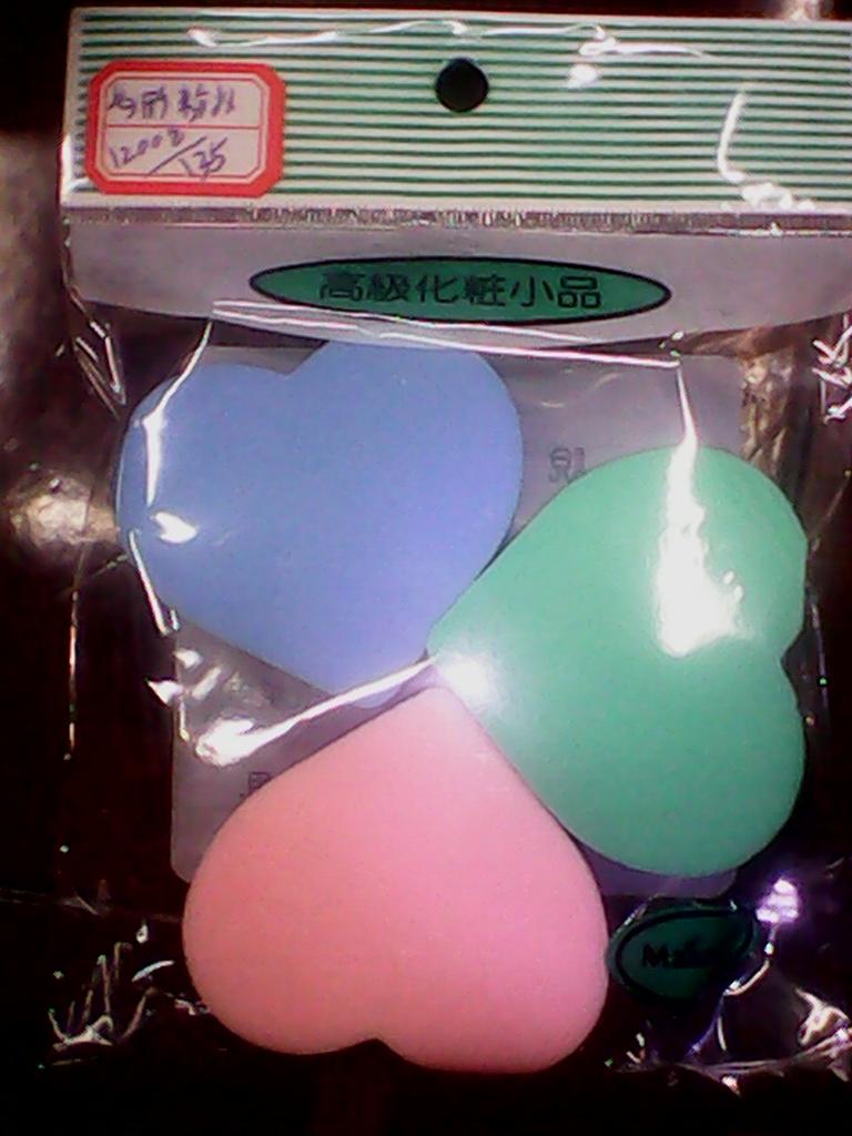 Three heart-shaped powder puffs