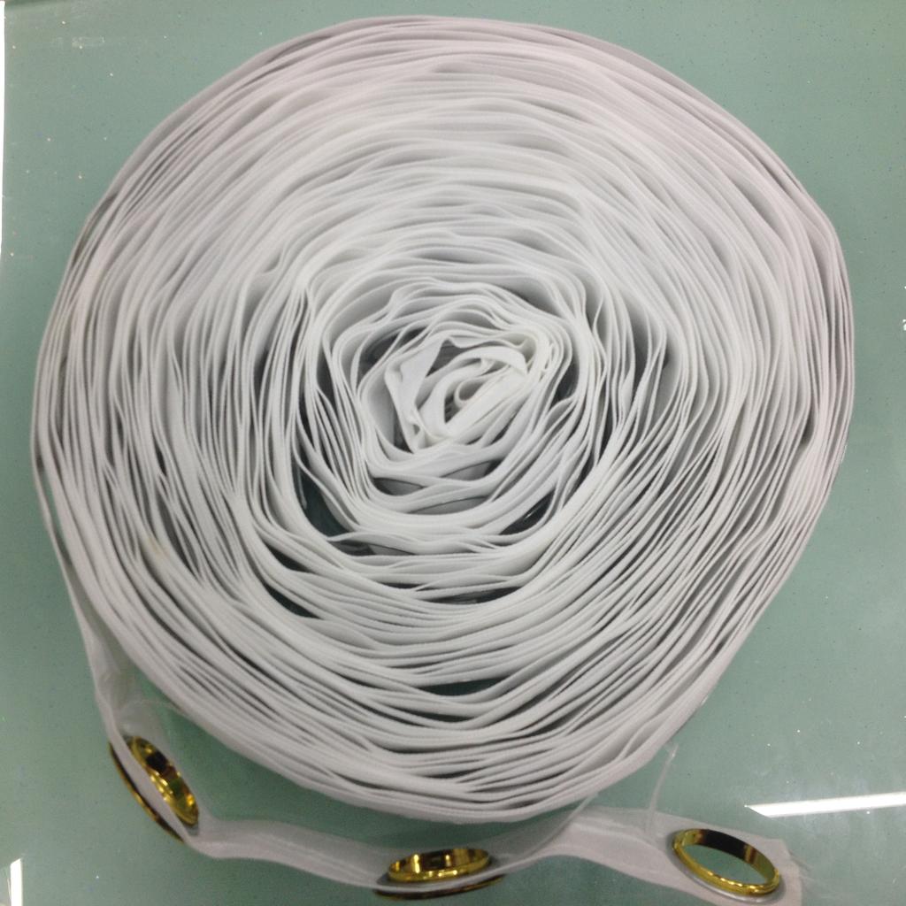 Installed Woven Punch Tape on curtains showing neat folds and smooth hanging