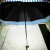 A fresh and light sun umbrella with blue and white striped borders and a golden border with a rubber handle details Picture