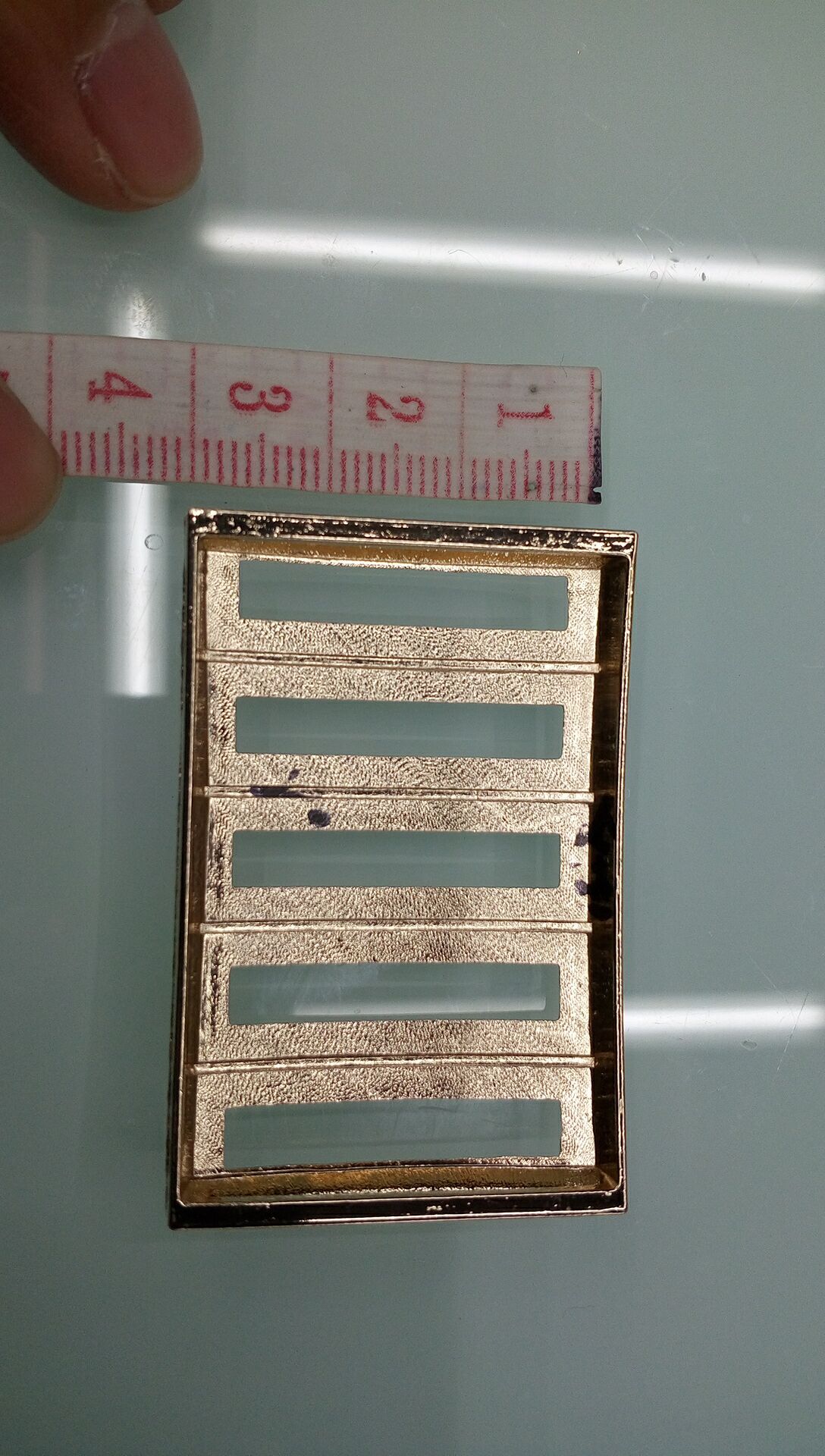 Multi-material belt buckle display