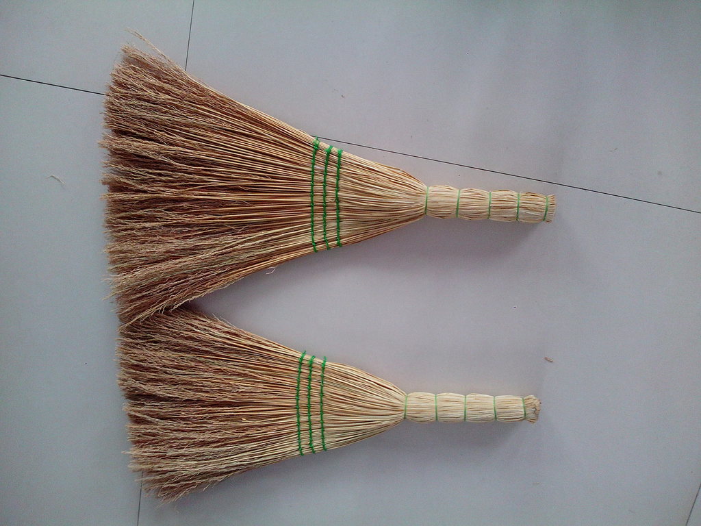 A large supply of wheat straw brooms and straw broom disposal