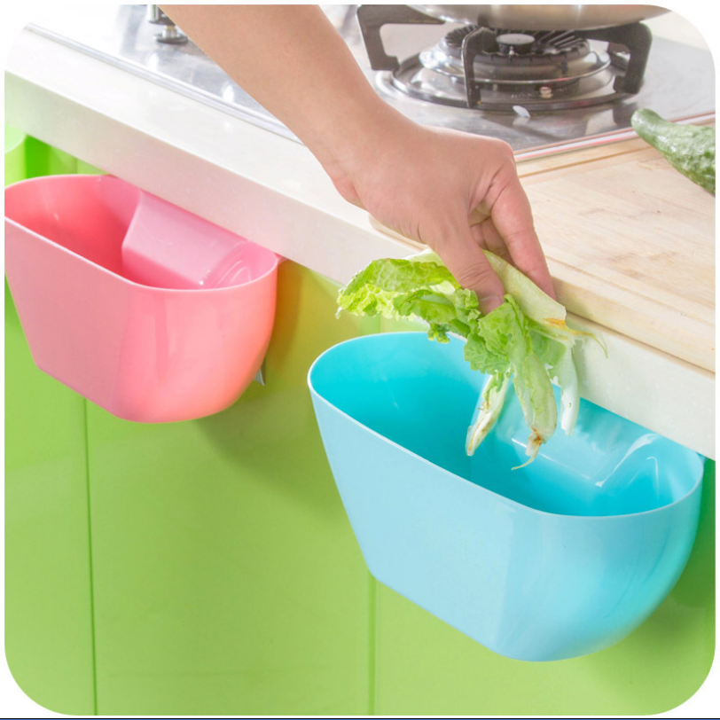 Creative hanging storage box for garbage on plastic table behind kitchen door