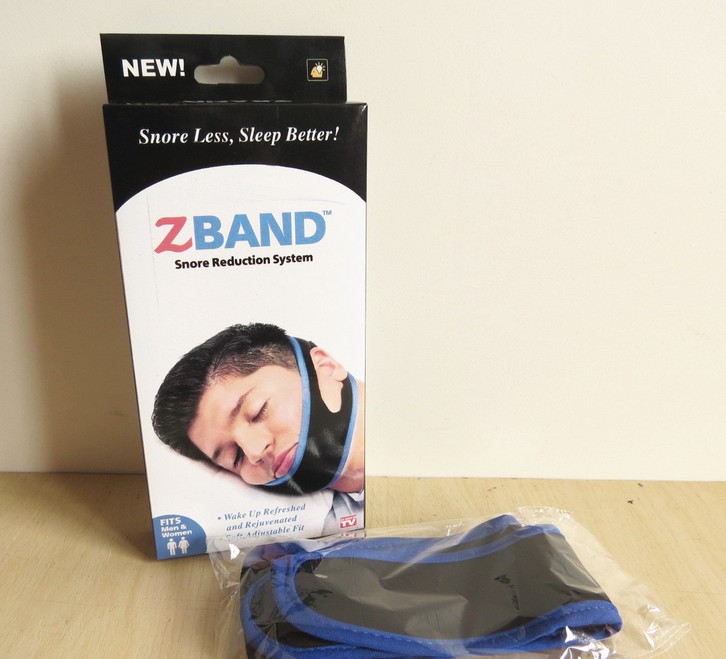A thin face with an anti-snoring device and ZBAND chin strap with a nasal snore strap