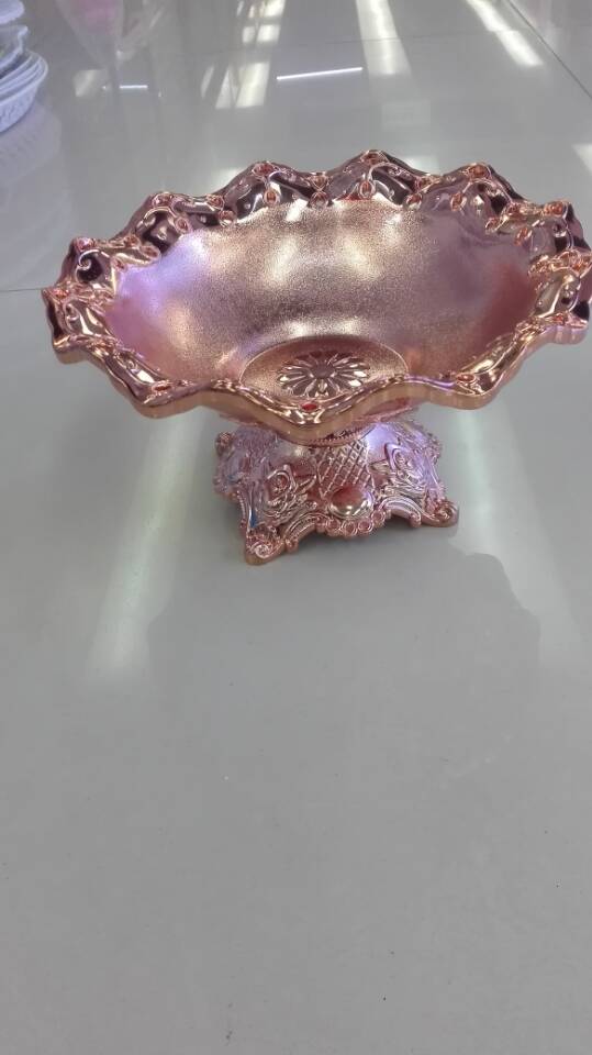 A golden fruit platter with feet added