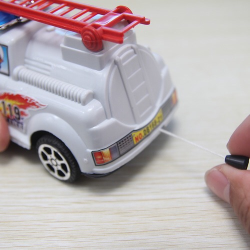 A fire engine with a pull wire, toys at a street stall Specification image