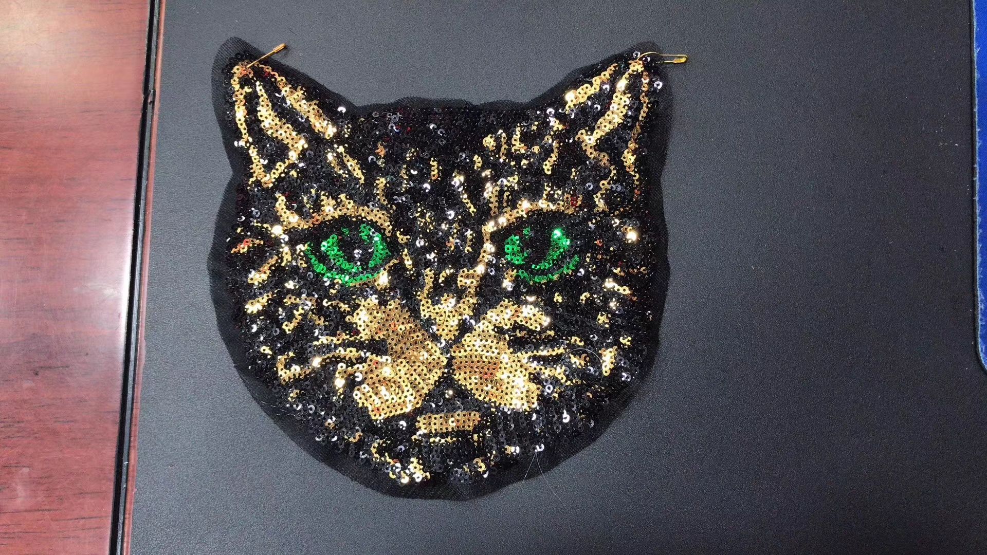 Beaded embroidered cat heads with green eyes are bestsellers Specification image