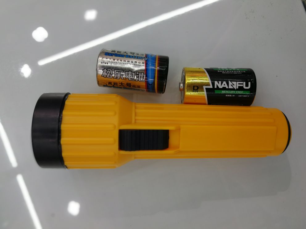 The old plastic yellow flashlight with a yellow bulb
