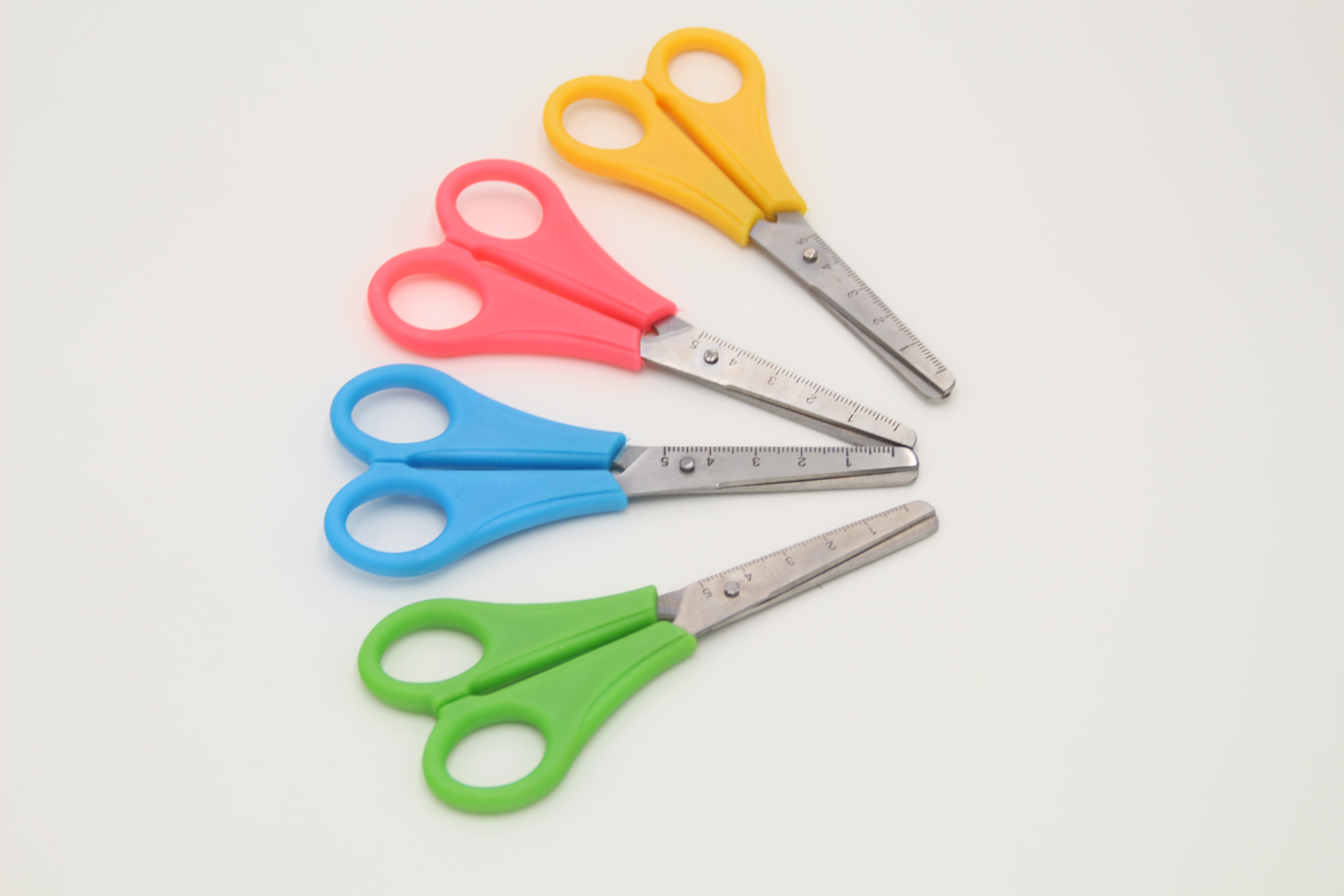 Students cut office scissors, paper-cutting knives and plastic scissors full figure