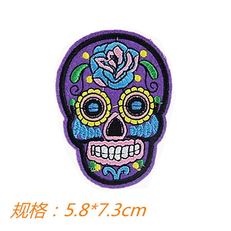 Assortment of colorful embroidered skull patches laid out