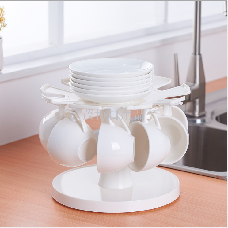 A rotating cup and saucer holder. A cup and saucer holder. A cup and saucer holder
