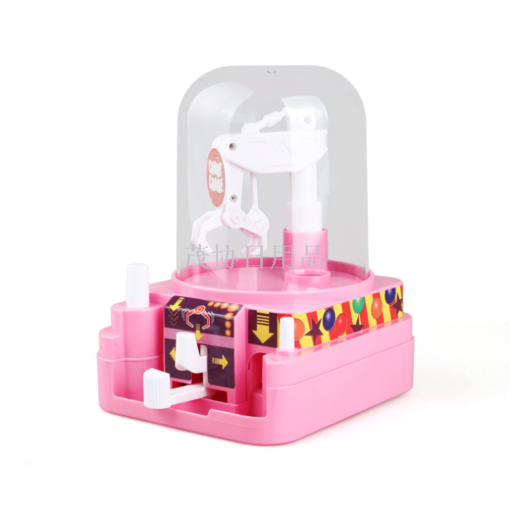 The new children's mini music grab machine moves the miniature clip doll grab candy electromechanical play gift