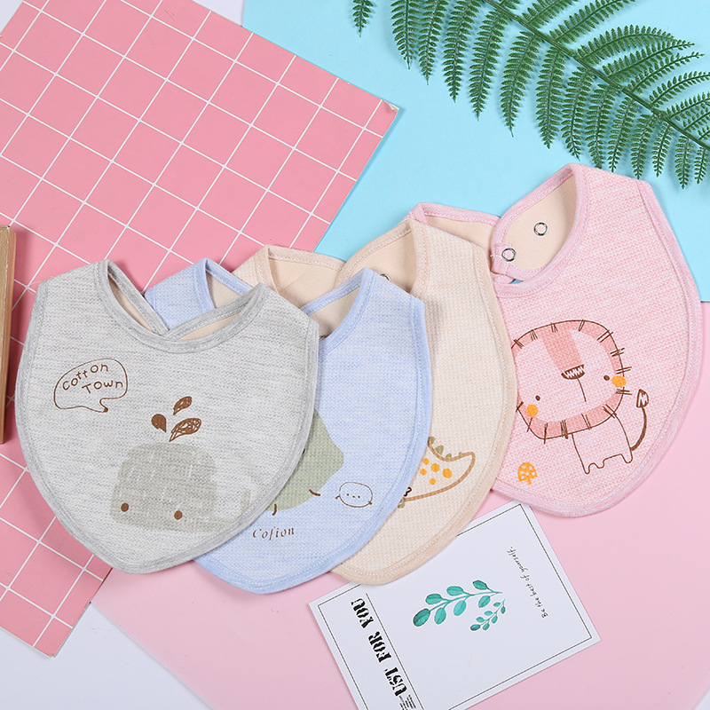 The manufacturer wholesals the new type of color cotton printed snap button adjustable baby cartoon cute triangular bib, which is selling well in spring