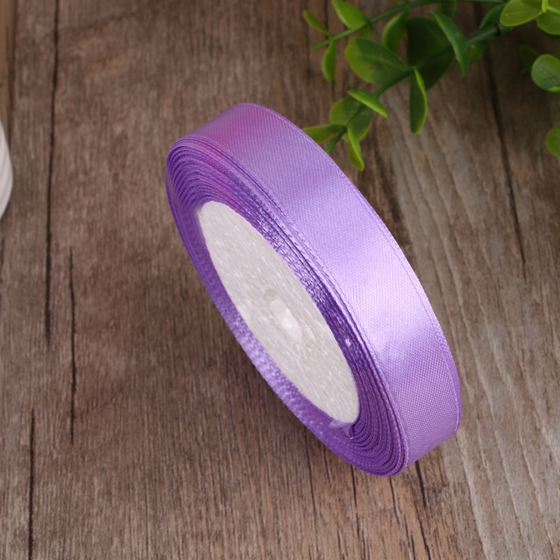 Layered ribbon techniques creating petal-like effects around a small jewelry box