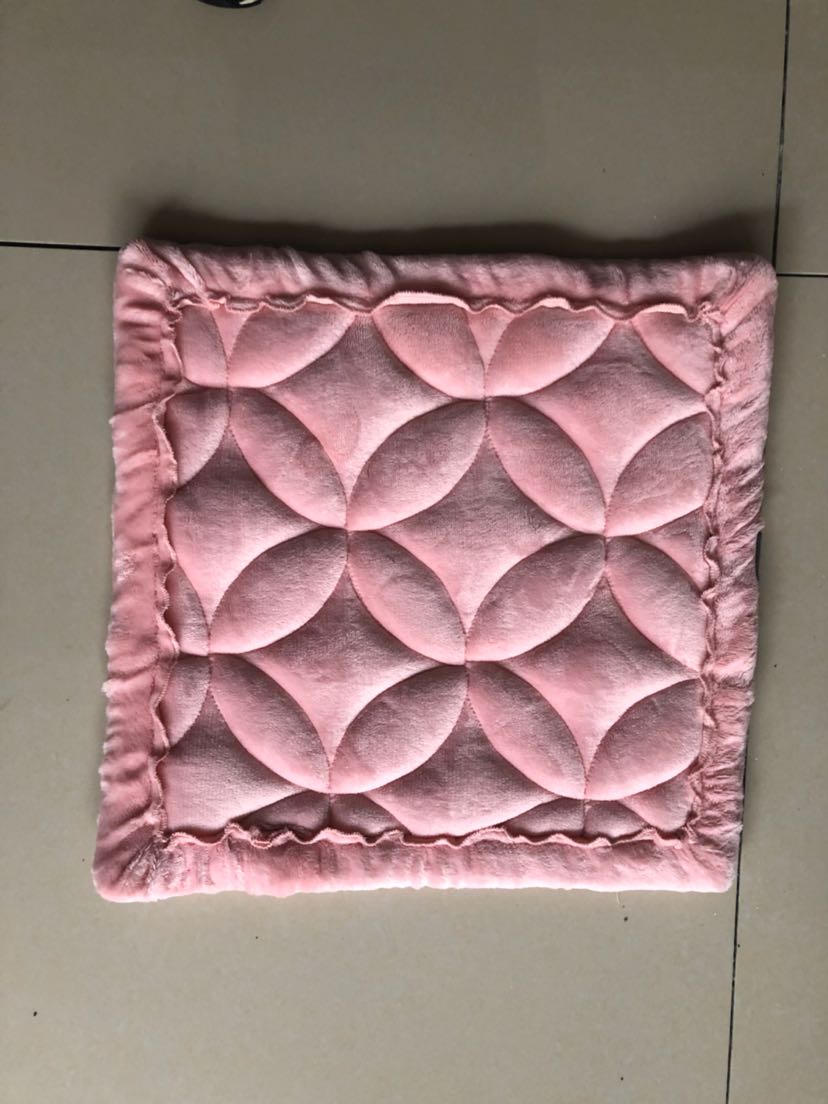 Assorted short plush cushions in different colors on a modern couch