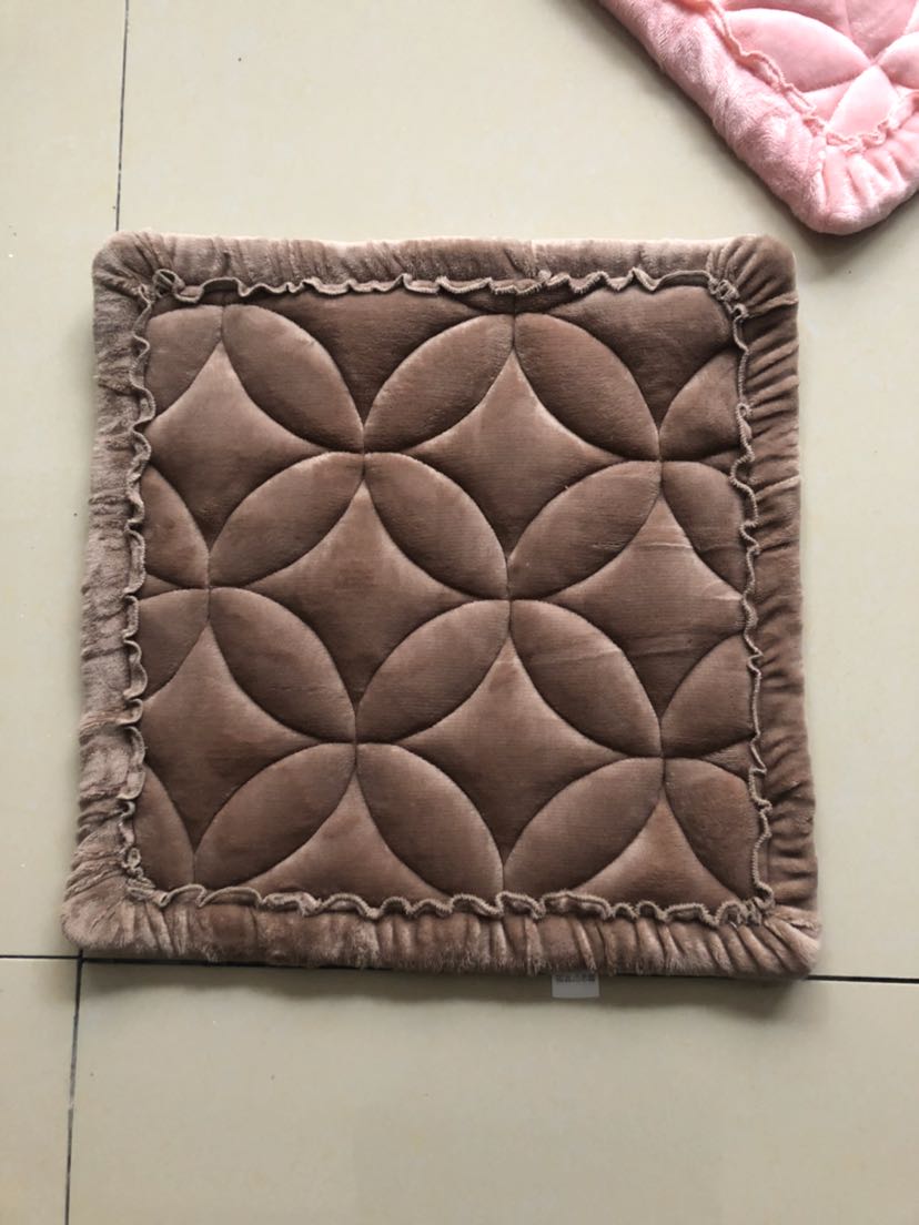 Close-up of plush cushion texture showing fine stitching and soft fabric
