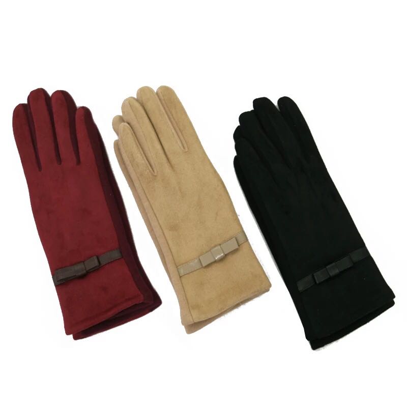 Women's suede gloves laid flat showing design details