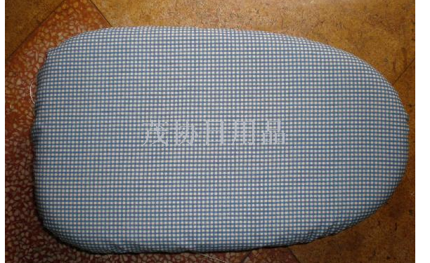 Plastic ironing board on table Ironing board