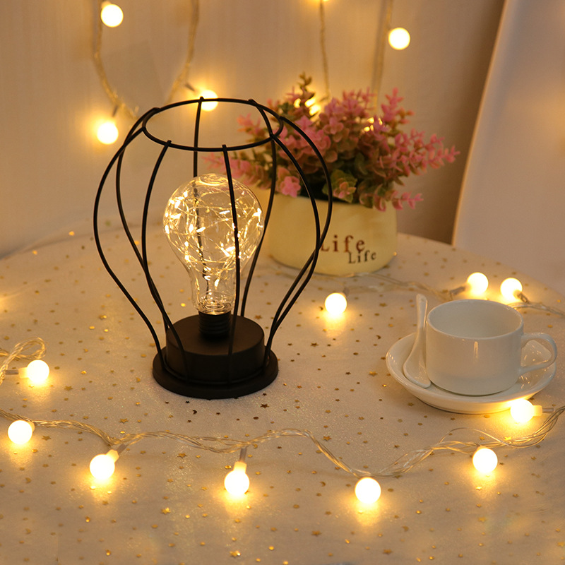 Decorative lighting in the bedroom of a vintage hotel. Holiday bedside table lamp