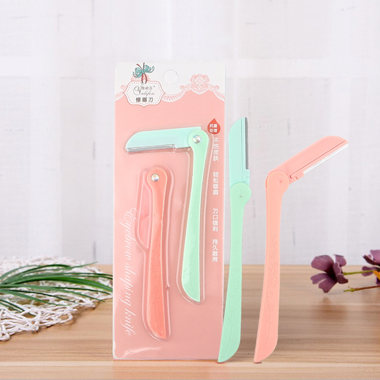Two foldable fashionable eyebrow shaping knives carry detachable blade heads and eyebrow shaping beauty tools