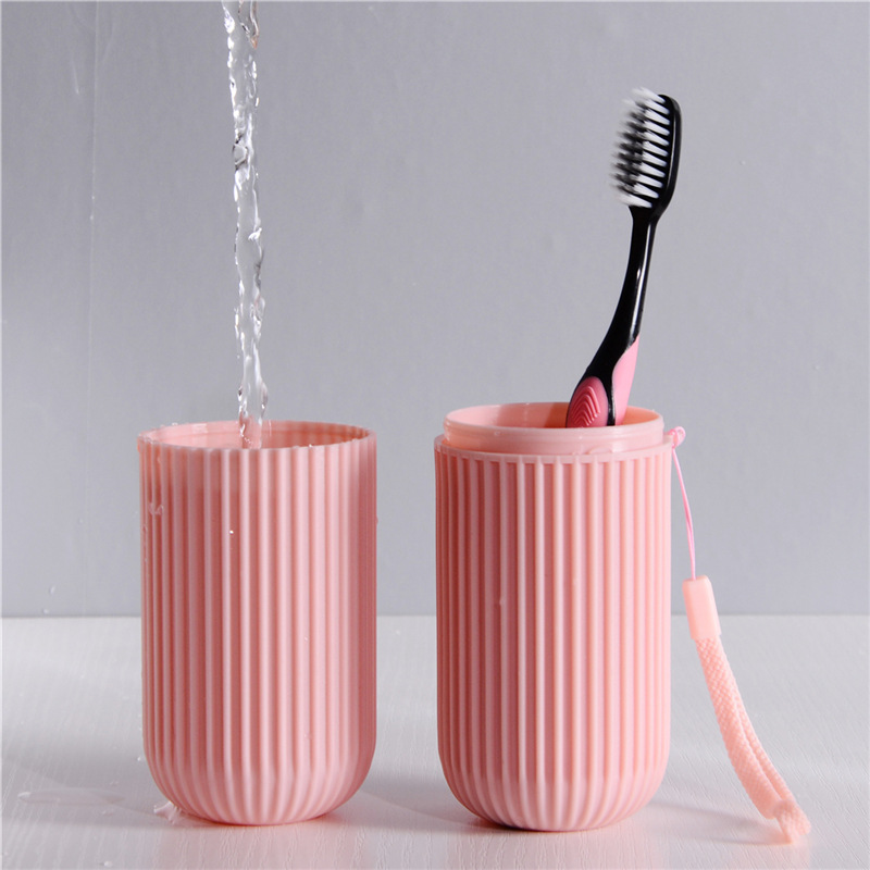 Vertical striped portable toiletry cup, travel toothbrush case, brushing cup, dental tool box, toothache cylinder, toothpaste storage cylinder Application Scenario