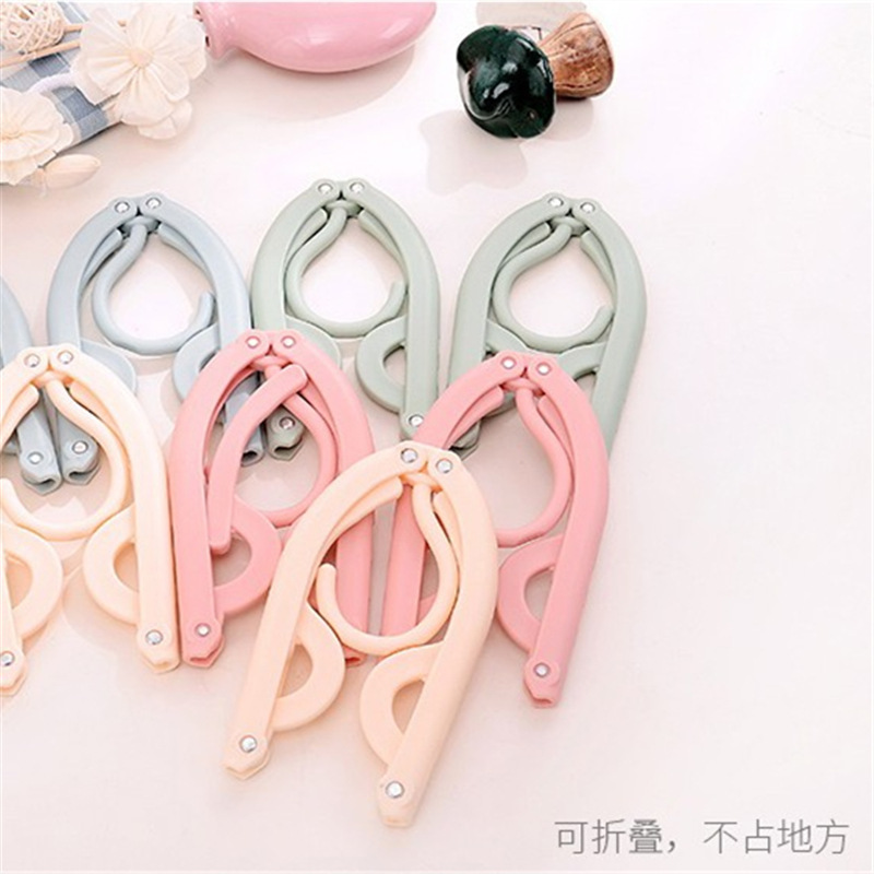 Wholesale of multi-functional magic travel folding clothes drying rack, portable children's storage plastic clothes rack, support and hanging rack